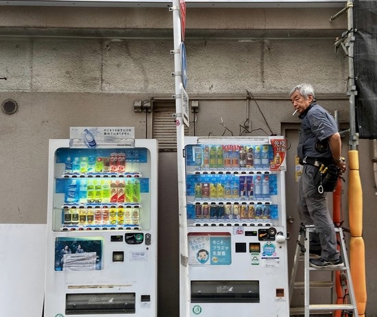 Technician beside two vending machines